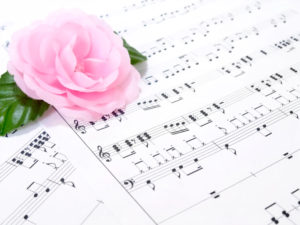 広げた楽譜にピンクのバラ